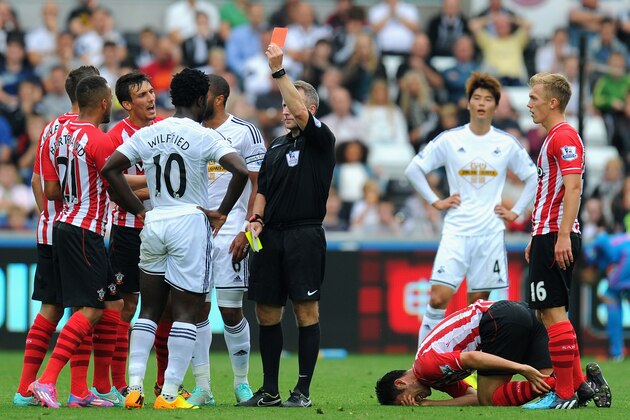 SWANSEA, WALES - SEPTEMBER 20:  Wilfried Bony of Swansea (10) receives a red card for a second bookable offence from referee Jonathan Moss for a foul on Maya Yoshida of Southampton during the Barclays Premier League match between Swansea City and Southampton at Liberty Stadium on September 20, 2014 in Swansea, Wales.  (Photo by Stu Forster/Getty Images)