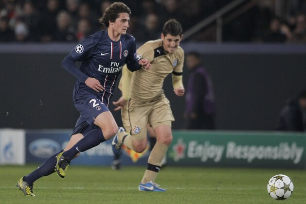 Paris Saint Germain's midfielder Adrien Rabiot, left, challenges for the ball with Dinamo Zagbreb's forward Ante Rukavina, right, during their  Champions League group A soccer match between Dinamo Zagreb and Paris Saint Germain, at the Parc des Princes Stadium, in Paris, Tuesday, Nov. 6, 2012. Paris Saint Germain defeated Dinamo Zagreb 4-0. (AP Photo/Thibault Camus)