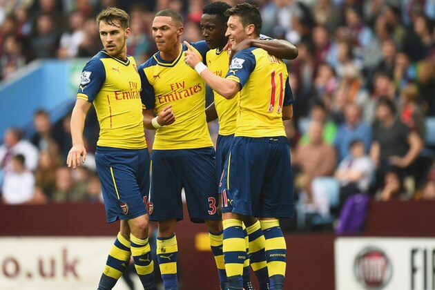 BIRMINGHAM, ENGLAND - SEPTEMBER 20: Mesut Oezil of Arsenal celebrates his goal with team mates during the Barclays Premier League match between Aston Villa and Arsenal at Villa Park on September 20, 2014 in Birmingham, England.  (Photo by Laurence Griffiths/Getty Images)
