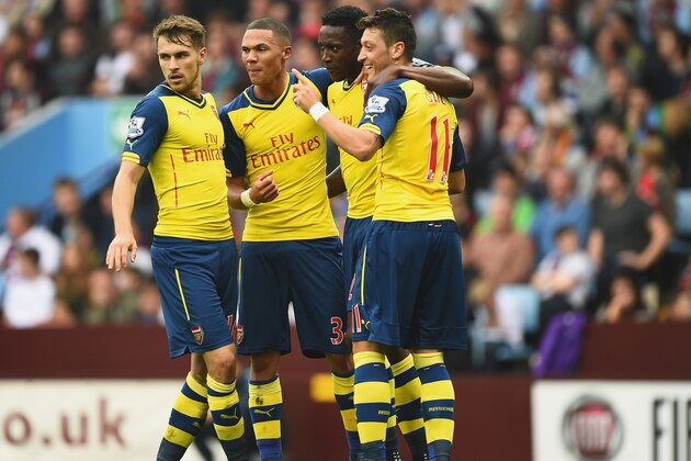 BIRMINGHAM, ENGLAND - SEPTEMBER 20: Mesut Oezil of Arsenal celebrates his goal with team mates during the Barclays Premier League match between Aston Villa and Arsenal at Villa Park on September 20, 2014 in Birmingham, England.  (Photo by Laurence Griffiths/Getty Images)