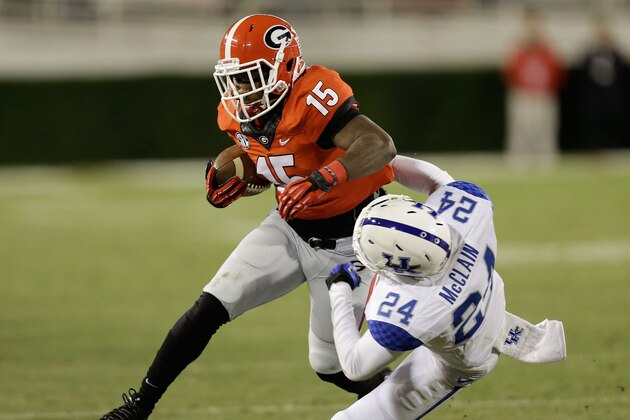 ATHENS, GA - NOVEMBER 23:  Running back J.J. Green #15 of the Georgia Bulldogs runs over defensive back Blake McClain #24 of the Kentucky Wildcats during the game at Sanford Stadium on November 23, 2013 in Athens, Georgia.  (Photo by Mike Zarrilli/Getty Images)