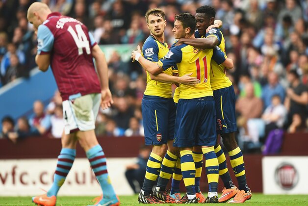BIRMINGHAM, ENGLAND - SEPTEMBER 20:  Mesut Oezil of Arsenal celebrates his goal with team mates during the Barclays Premier League match between Aston Villa and Arsenal at Villa Park on September 20, 2014 in Birmingham, England.  (Photo by Laurence Griffiths/Getty Images)