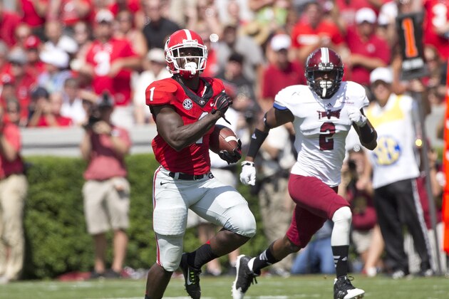 Georgia running back Sony Michel (1) breaks free for a gain as Troy cornerback Keion Payne (2) gives chase in the first half of an NCAA college football game Saturday, Sept. 20, 2014, in Athens, Ga. (AP Photo/John Bazemore)