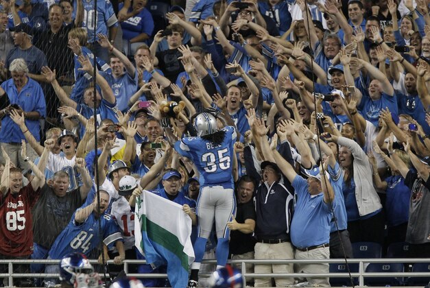 Detroit Lions running back Joique Bell (35) celebrates his touchdown during the fourth quarter of an NFL football game against the New York Giants with fans in Detroit, Monday, Sept. 8, 2014. (AP Photo/Duane Burleson)
