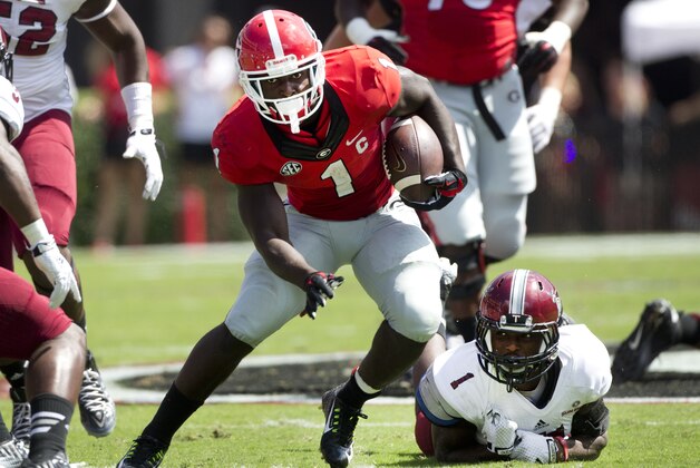 DUPLICATE***Georgia running back Sony Michel (1) gets past Troy defensive back Montres Kitchens (1) in the first half of an NCAA college football game Saturday, Sept. 20, 2014, in Athens, Ga. (AP Photo/John Bazemore)