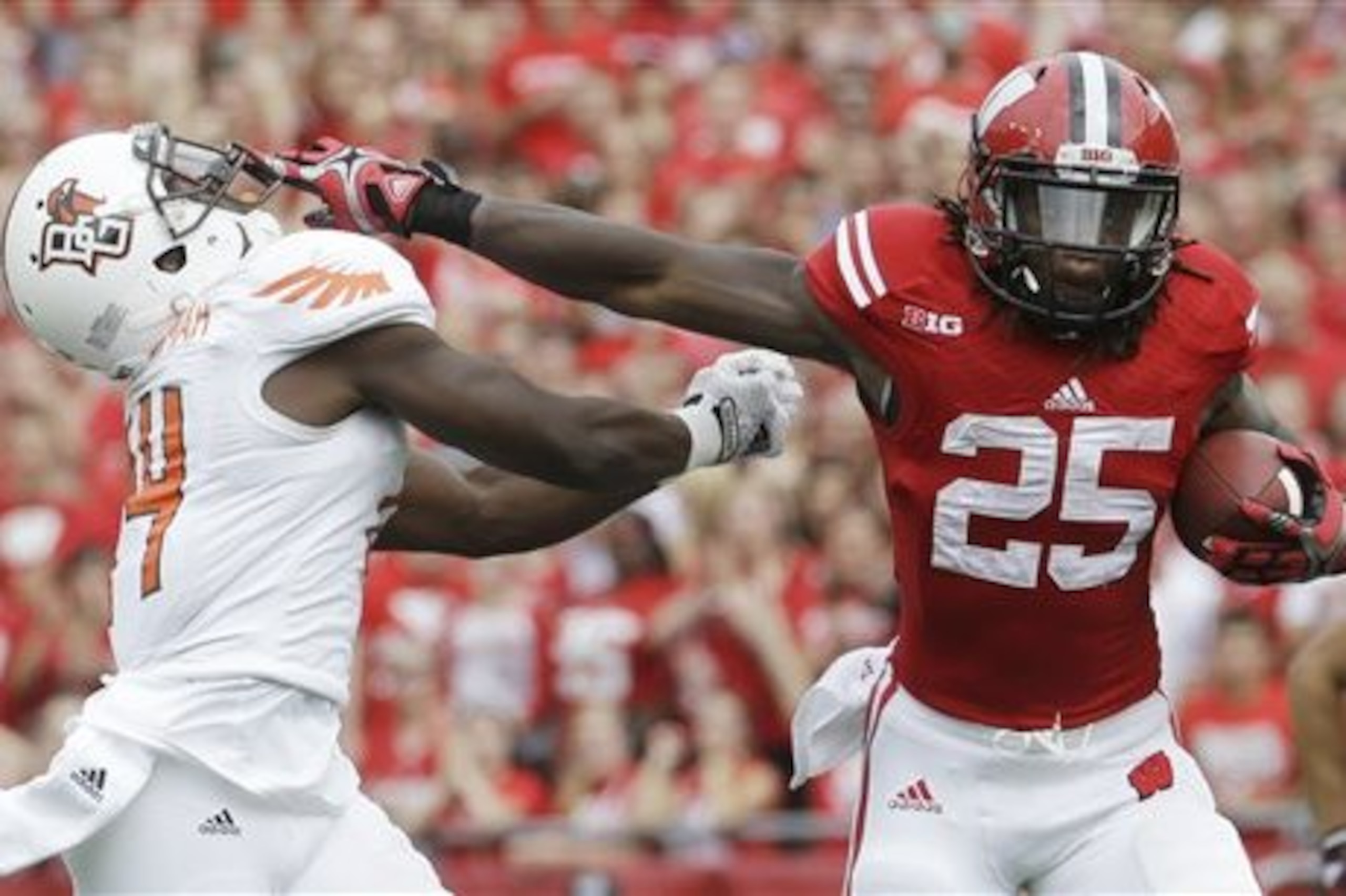 Wisconsin's Melvin Gordon (25) breaks away from Bowling Green's Jude Adjei-Barimah for a 50-yard touchdown run during the first half of an NCAA college football game, Saturday, Sept. 20, 2014, in Madison, Wis. (AP Photo/Morry Gash)