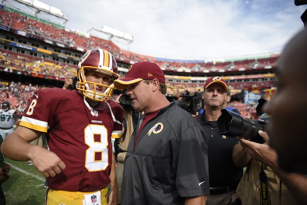 Washington Redskins quarterback Kirk Cousins (8) talks with head coach Jay Gruden, right, after an NFL football game Sunday, Sept. 14, 2014, in Landover, Md. The Redskins won 41-10. (AP Photo/Nick Wass)