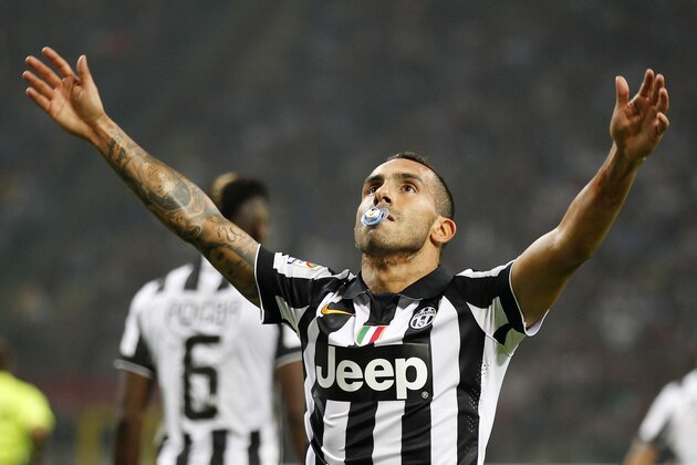 Juventus's Carlos Tevez celebrates after scoring during the Serie A soccer match between AC Milan and Juventus at the San Siro stadium in Milan, Italy, Saturday, Sept. 20, 2014. (AP Photo/Antonio Calanni)