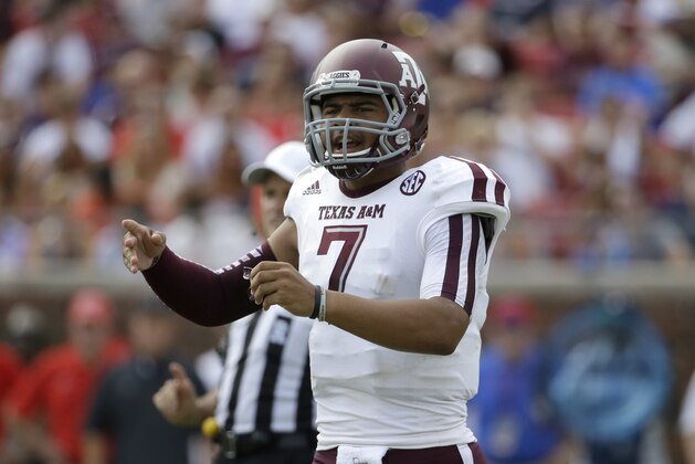 Texas A&M quarterback Kenny Hill (7) instructs his team at the line of scrimmage in the first half of an NCAA college football game against SMU,  Saturday, Sept. 20, 2014, in Dallas. (AP Photo/Tony Gutierrez)