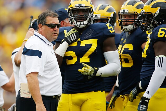 ANN ARBOR, MI - SEPTEMBER 20:  Head coach Brady Hoke talks with Frank Clark #57 during the first quarter while playing the Utah Utes on September 20, 2014 at Michigan Stadium in Ann Arbor, Michigan.  (Photo by Gregory Shamus/Getty Images)