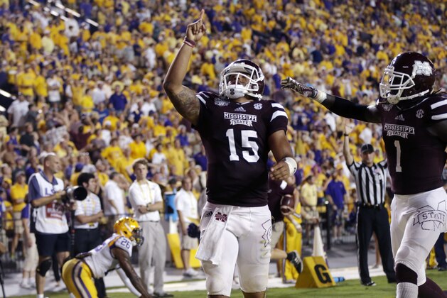 Mississippi State quarterback Dak Prescott (15) celebrates his 56 yard touchdown carry with wide receiver De'Runnya Wilson (1) in the second half of an NCAA college football game against Mississippi State in Baton Rouge, La., Saturday, Sept. 20, 2014. (AP Photo/Gerald Herbert)