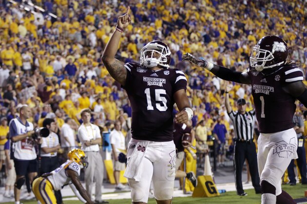 Mississippi State quarterback Dak Prescott (15) celebrates his 56 yard touchdown carry with wide receiver De'Runnya Wilson (1) in the second half of an NCAA college football game against Mississippi State in Baton Rouge, La., Saturday, Sept. 20, 2014. (AP Photo/Gerald Herbert)