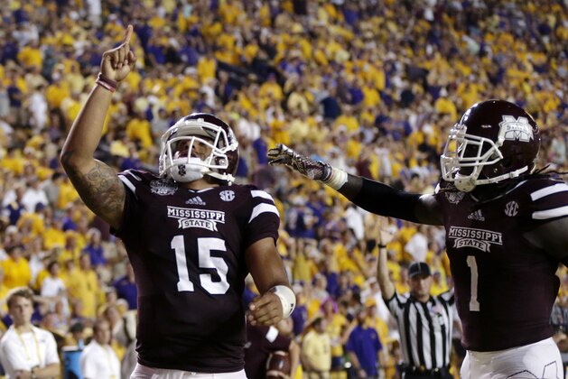 Mississippi State quarterback Dak Prescott (15) celebrates his 56 yard touchdown run with wide receiver De'Runnya Wilson (1) in the second half of an NCAA college football game against Mississippi State in Baton Rouge, La., Saturday, Sept. 20, 2014. (AP Photo/Gerald Herbert)