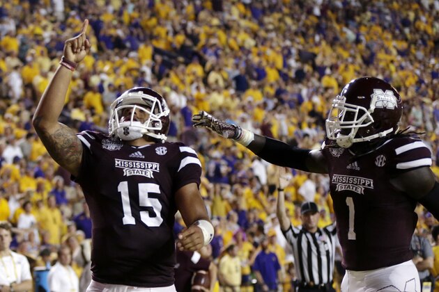 Mississippi State quarterback Dak Prescott (15) celebrates his 56 yard touchdown run with wide receiver De'Runnya Wilson (1) in the second half of an NCAA college football game against Mississippi State in Baton Rouge, La., Saturday, Sept. 20, 2014. (AP Photo/Gerald Herbert)