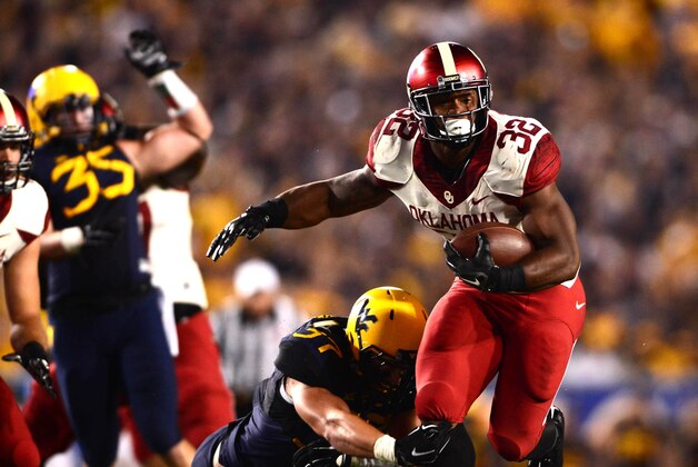 Sep 20, 2014; Morgantown, WV, USA; Oklahoma Sooners running back Samaje Perine (32) runs the ball during the second quarter against the West Virginia Mountaineers at Milan Puskar Stadium. Mandatory Credit: Andrew Weber-USA TODAY Sports