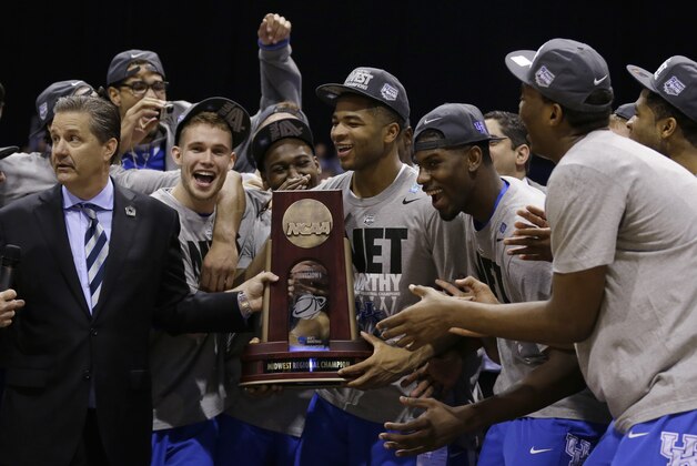 Kentucky head coach John Calipari, left, and players celebrate after an NCAA Midwest Regional final college basketball tournament game Sunday, March 30, 2014, in Indianapolis. Kentucky won 75-72 to advance to the Final Four. (AP Photo/Michael Conroy)