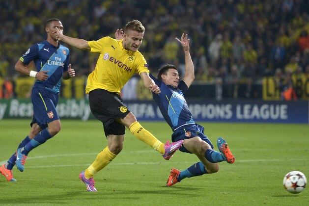 Dortmund's Ciro Immobile, center, scores his side's opening goal during the Champions League group D soccer match between Borussia Dortmund and Arsenal in Dortmund, Germany, Tuesday, Sept.16, 2014. (AP Photo/Martin Meissner)