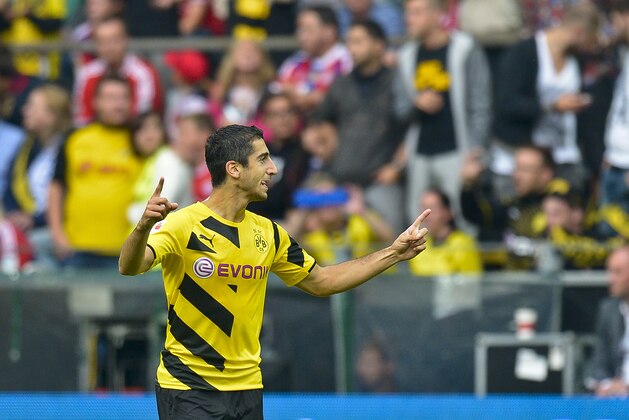 Dortmund's Henrikh Mkhitaryan celebrates his opening goal during the German soccer Super Cup match between Borussia Dortmund and Bayern Munich in Dortmund, Germany, Wednesday, Aug. 13, 2014. (AP Photo/Sascha Schuermann)