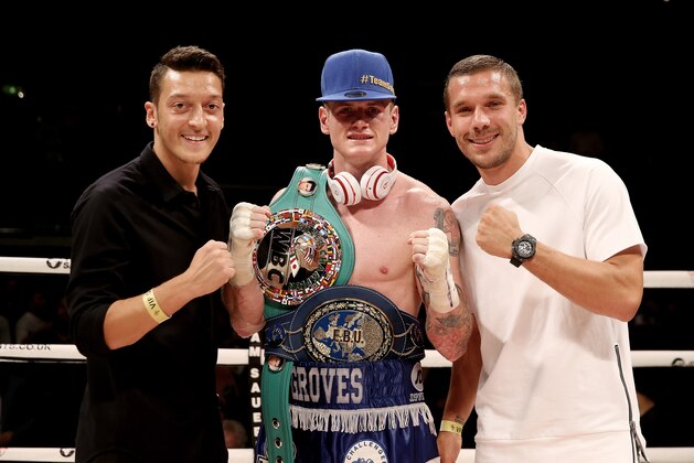 LONDON, ENGLAND - SEPTEMBER 20:  George Groves celebrates his victory over Christopher Rebrasse with Arsenal's Mezut Ozil and Lukas Podolski during their WBC Final Eliminator & European Super Middleweight bout at Wembley Arena on September 20, 2014 in London, England.  (Photo by Scott Heavey/Getty Images)
