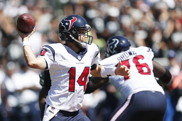 Houston Texans quarterback Ryan Fitzpatrick throws in the first quarter of an NFL football game against the Oakland Raiders Sunday, Sept. 14, 2014, in Oakland, Calif. At right is Houston Texans tackle Duane Brown. (AP Photo/Beck Diefenbach)