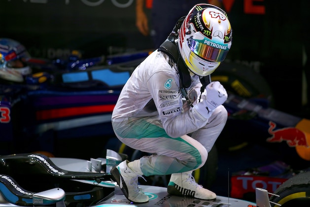 SINGAPORE - SEPTEMBER 21:  Lewis Hamilton of Great Britain and Mercedes GP celebrates in Parc Ferme after winning the Singapore Formula One Grand Prix at Marina Bay Street Circuit on September 21, 2014 in Singapore, Singapore.  (Photo by Mark Thompson/Getty Images)