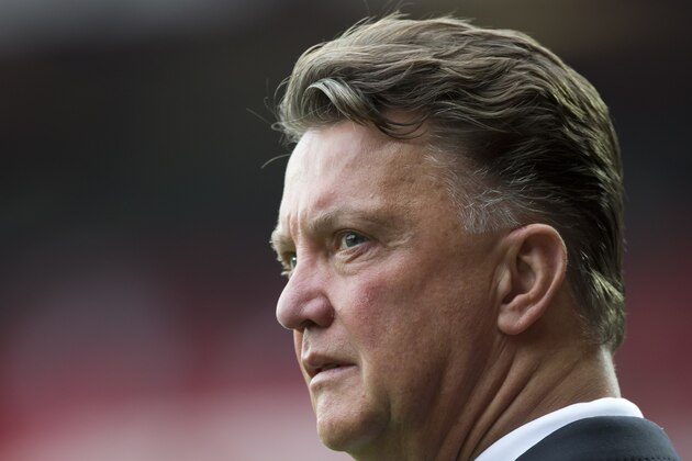 Manchester United's manager Louis van Gaal stands on the touchline before his team's English Premier League soccer match against Queens Park Rangers at Old Trafford Stadium, Manchester, England, Sunday Sept. 14, 2014. (AP Photo/Jon Super)