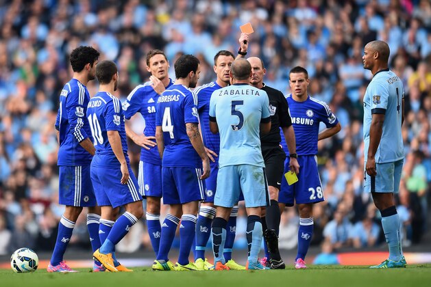 MANCHESTER, ENGLAND - SEPTEMBER 21:  
Referee Mike Dean shows a red card to Pablo Zabaleta of Manchester City during the Barclays Premier League match between Manchester City and Chelsea at the Etihad Stadium on September 21, 2014 in Manchester, England.  (Photo by Shaun Botterill/Getty Images)