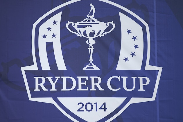 An abseiler works on hanging a drape with a Ryder Cup logo on the side of a spectator grandstand in preparation for the start of the Ryder Cup golf tournament in Gleneagles, Scotland, Sunday, Sept. 21, 2014.  The U.S. team arrives for the Ryder Cup Monday, with the tournament  starting on Friday.  (AP Photo/Matt Dunham)