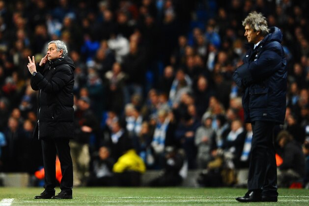 MANCHESTER, ENGLAND - FEBRUARY 03:  Manuel Pellegrini manager of Manchester City looks on as  Jose Mourinho manager of Chelsea give instructions during the Barclays Premier League match between Manchester City and Chelsea at Etihad Stadium on February 3, 2014 in Manchester, England.  (Photo by Laurence Griffiths/Getty Images)