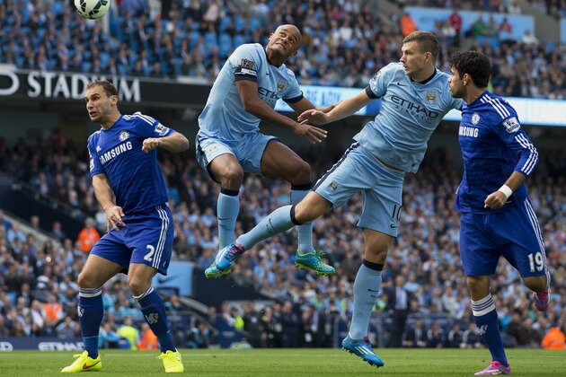 Manchester City's Edin Dzeko, second right and Vincent Kompany, centre left, jump for a ball as Chelsea's Branislav Ivanovic, left, and Diego Costa look on during their English Premier League soccer match at the Etihad Stadium, Manchester, England, Sunday Sept. 21, 2014. (AP Photo/Jon Super) Manchester City's Edin Dzeko, second right and Vincent Kompany, centre left, jump for a ball as Chelsea's Branislav Ivanovic, left, and Diego Costa look on during their English Premier League soccer match at the Etihad Stadium, Manchester, England, Sunday Sept. 21, 2014. (AP Photo/Jon Super)