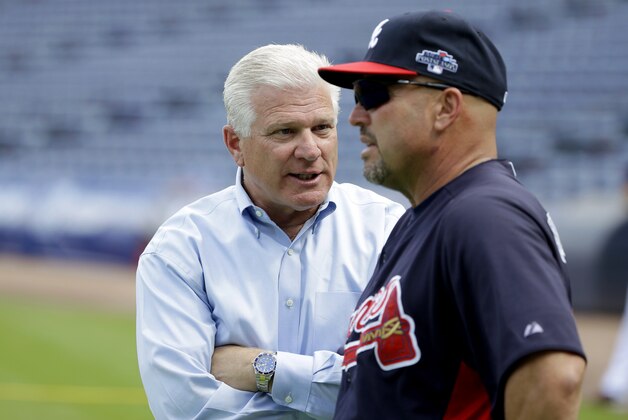 Atlanta Braves manager Fredi Gonzalez, right, talks with general manager Frank Wren during a baseball practice on Wednesday, Oct. 2, 2013, in Atlanta. The Los Angeles Dodgers are to play the Braves in Game 1 of the National League Division Series in Atlanta, Thursday. (AP Photo/David Goldman)
