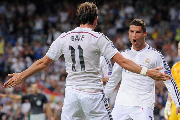 MADRID, SPAIN - SEPTEMBER 16:  Cristiano Ronaldo of Real Madrid celebrates with Gareth Bale after scoring Real's 3rd goal during the UEFA Champions League Group B match between Real Madrid CF and FC Basel 1893 on September 16, 2014 in Madrid, Spain.  (Photo by Denis Doyle/Getty Images)