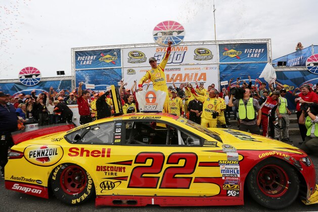 LOUDON, NH - SEPTEMBER 21:  Joey Logano, driver of the #22 Shell-Pennzoil Ford, celebrates in victory lane after winning the NASCAR Sprint Cup Series Sylvania 300 at New Hampshire Motor Speedway on September 21, 2014 in Loudon, New Hampshire.  (Photo by Jerry Markland/Getty Images)