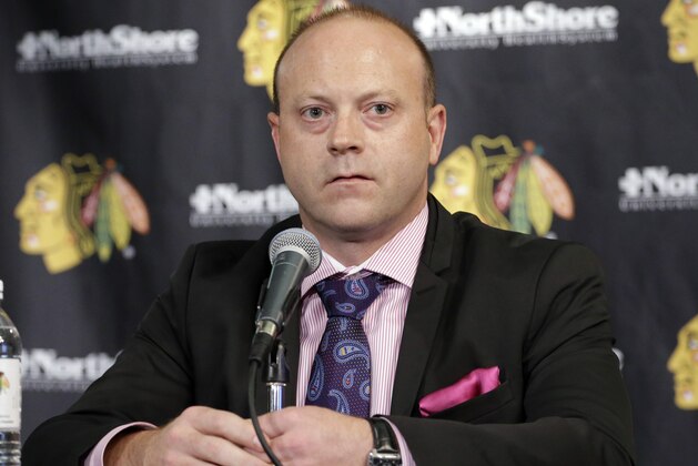 Chicago Blackhawks Vice President/General Manager Stan Bowman, listens to the media during a news conference at the United Center in Chicago, Wednesday, July 16, 2014. The Blackhawks recently agreed to eight-year contract extensions with Toews and Kane. (AP Photo/Nam Y. Huh)