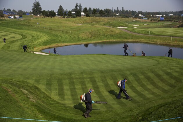 Greenskeepers work on the course in preparation for the start of the Ryder Cup golf tournament in Gleneagles, Scotland, Sunday, Sept. 21, 2014.  The U.S. team arrives for the Ryder Cup Monday, with the tournament  starting on Friday.  (AP Photo/Matt Dunham)