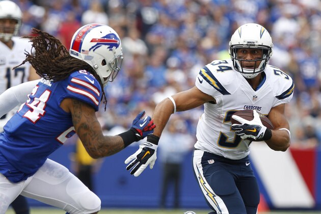 San Diego Chargers running back Donald Brown (34) rushes away from Buffalo Bills' Stephon Gilmore (24) during the first half of an NFL football game Sunday, Sept. 21, 2014, in Orchard Park, N.Y. (AP Photo/Bill Wippert)