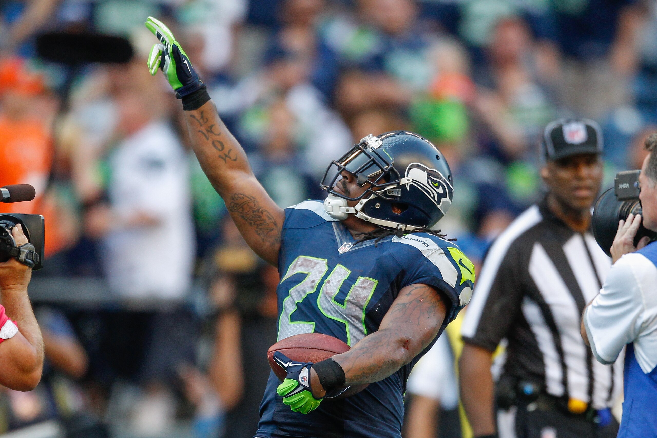 SEATTLE, WA - SEPTEMBER 21: Running back Marshawn Lynch #24 of the Seattle Seahawks celebrates after rushing for the winning touchdown in overtime against the Denver Broncos at CenturyLink Field on September 21, 2014 in Seattle, Washington. The Seahawks defeated the Broncos 26-20. (Photo by Otto Greule Jr/Getty Images) SEATTLE, WA - SEPTEMBER 21: Running back Marshawn Lynch #24 of the Seattle Seahawks celebrates after rushing for the winning touchdown in overtime against the Denver Broncos at CenturyLink Field on September 21, 2014 in Seattle, Washington. The Seahawks defeated the Broncos 26-20. (Photo by Otto Greule Jr/Getty Images)
