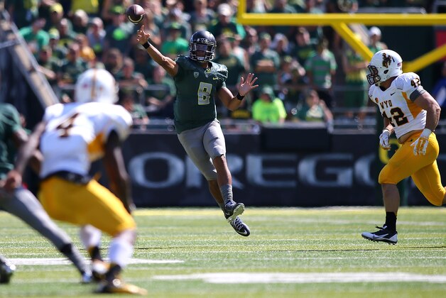 EUGENE, OR - SEPTEMBER 13:  Quarterback Marcus Mariota #8 of the Oregon Ducks throws the ball against the Wyoming Coyboys at Autzen Stadium on September 13, 2014 in Eugene, Oregon.  (Photo by Jonathan Ferrey/Getty Images)