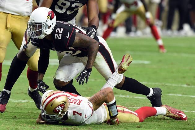 GLENDALE, AZ - SEPTEMBER 21:  Quarterback Colin Kaepernick #7 of the San Francisco 49ers is hit by safety Tony Jefferson #22 of the Arizona Cardinals during the second half of NFL game at University of Phoenix Stadium on September 21, 2014 in Glendale, Arizona.  (Photo by Norm Hall/Getty Images)