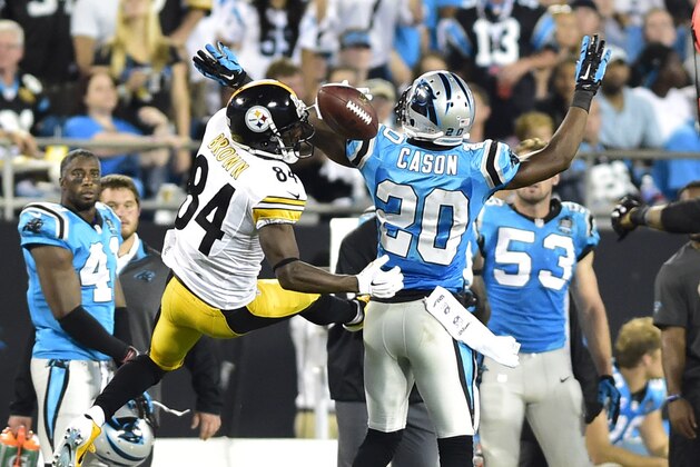 Sep 21, 2014; Charlotte, NC, USA; Carolina Panthers cornerback Antoine Cason (20) is called for pass interference as he breaks up a pass intended for Pittsburgh Steelers wide receiver Antonio Brown (84) in the second quarter at Bank of America Stadium. Mandatory Credit: Bob Donnan-USA TODAY Sports
