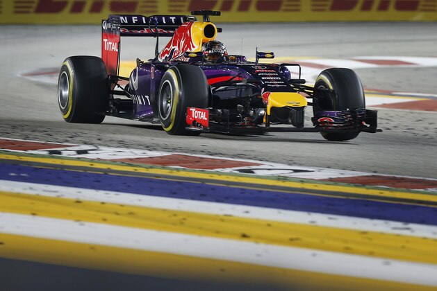Red Bull Racing driver Sebastian Vettel of Germany steers his car during the Singapore Formula One Grand Prix on the Marina Bay City Circuit in Singapore, Sunday, Sept. 21, 2014. (AP Photo/Ng Han Guan)