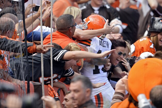 Cleveland Browns wide receiver Miles Austin leaps into the crowd after a touchdown catch against the Baltimore Ravens in the third quarter of an NFL football game Sunday, Sept. 21, 2014, in Cleveland. (AP Photo/David Richard)