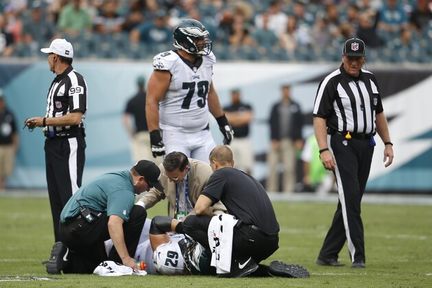 Trainers work on Philadelphia Eagles center Jason Kelce (62) during the second half of an NFL football game against the Washington Redskins, Sunday, Sept. 21, 2014, in Philadelphia. (AP Photo/Michael Perez)