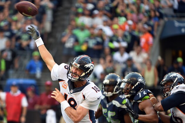 SEATTLE, WA - SEPTEMBER 21: Quarterback Peyton Manning #18 of the Denver Broncos throws a touchdown pass during the fourth quarter of the game against the Seattle Seahawks at CenturyLink Field on September 21, 2014 in Seattle,Washington. The Seahawks won the game 26-20. (Photo by Steve Dykes/Getty Images)
