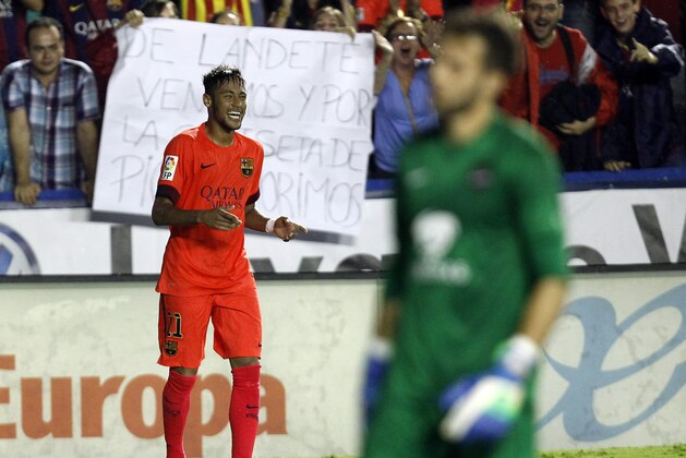 Barcelona's Neymar, from Brazil,  celebrates after scoring against Levante during a Spanish La Liga soccer match at the Ciutat de Valencia stadium in Valencia, Spain, on Sunday, Sept. 21, 2014.(AP Photo/Alberto Saiz)