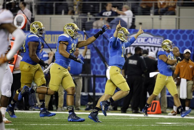 UCLA quarterback Jerry Neuheisel (11), Matt Dickerson (99) and Malcolm Bunche (78) celebrate after UCLA scored a touchdown against Texas in the final minutes of an NCAA college football game, Saturday, Sept. 13, 2014, in Arlington, Texas. UCLA won 20-17. (AP Photo/Tony Gutierrez) UCLA quarterback Jerry Neuheisel (11), Matt Dickerson (99) and Malcolm Bunche (78) celebrate after UCLA scored a touchdown against Texas in the final minutes of an NCAA college football game, Saturday, Sept. 13, 2014, in Arlington, Texas. UCLA won 20-17. (AP Photo/Tony Gutierrez)