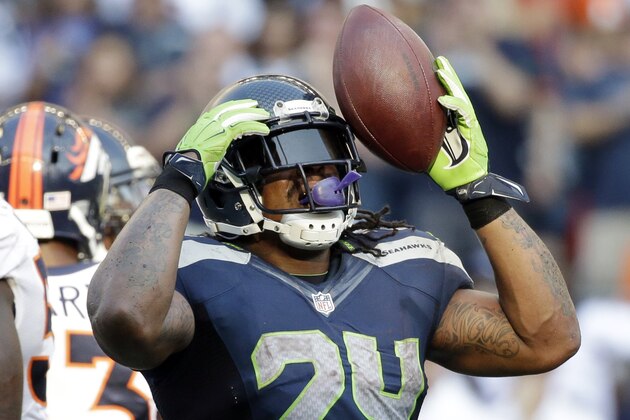 Seattle Seahawks' Marshawn Lynch reacts after rushing for a first down against the Denver Broncos in overtime of an NFL football game, Sunday, Sept. 21, 2014, in Seattle. The Seahawks won 26-20. (AP Photo/Elaine Thompson)