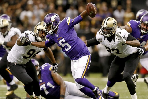 Sep 21, 2014; New Orleans, LA, USA; Minnesota Vikings quarterback Teddy Bridgewater (5) is pressured by New Orleans Saints outside linebacker Junior Galette (93) and defensive end Cameron Jordan (94) during the second half of a game at Mercedes-Benz Superdome. The Saints defeated the Vikings 20-9. Mandatory Credit: Derick E. Hingle-USA TODAY Sports
