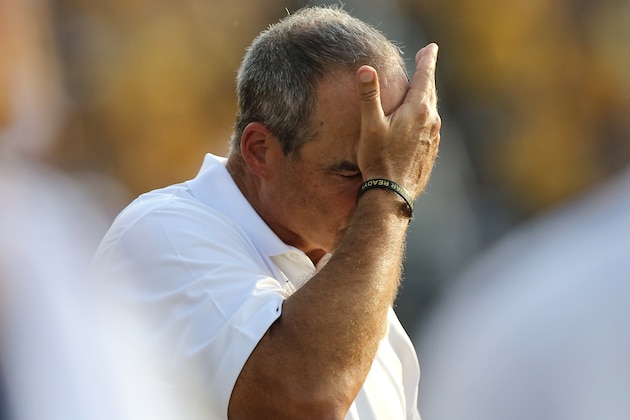 COLUMBIA , MO - SEPTEMBER 20:  Missouri head coach Gary Pinkel wipes his face as he walks the sideline in the third quarter during a game against the Indiana Hoosiers at Memorial Stadium on September 20, 2014 in Columbia, Missouri.  Indiana won 31-27.(Photo by Ed Zurga/Getty Images)