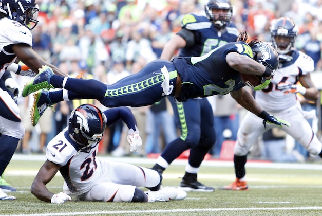 Sep 21, 2014; Seattle, WA, USA; Seattle Seahawks running back Marshawn Lynch (24) rushes for a touchdown against the Denver Broncos during overtime at CenturyLink Field. Seattle defeated Denver, 26-20. Mandatory Credit: Joe Nicholson-USA TODAY Sports